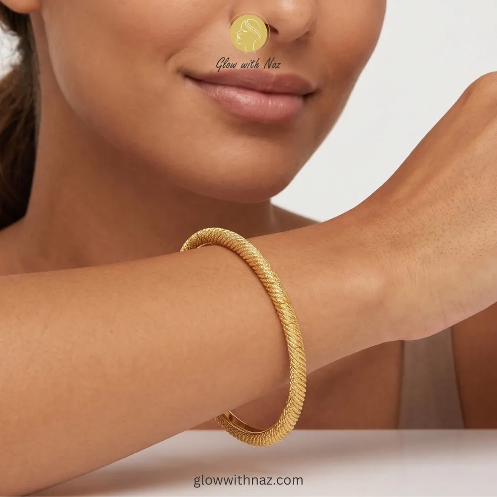 Minimalist twisted gold bangle styled for everyday luxury