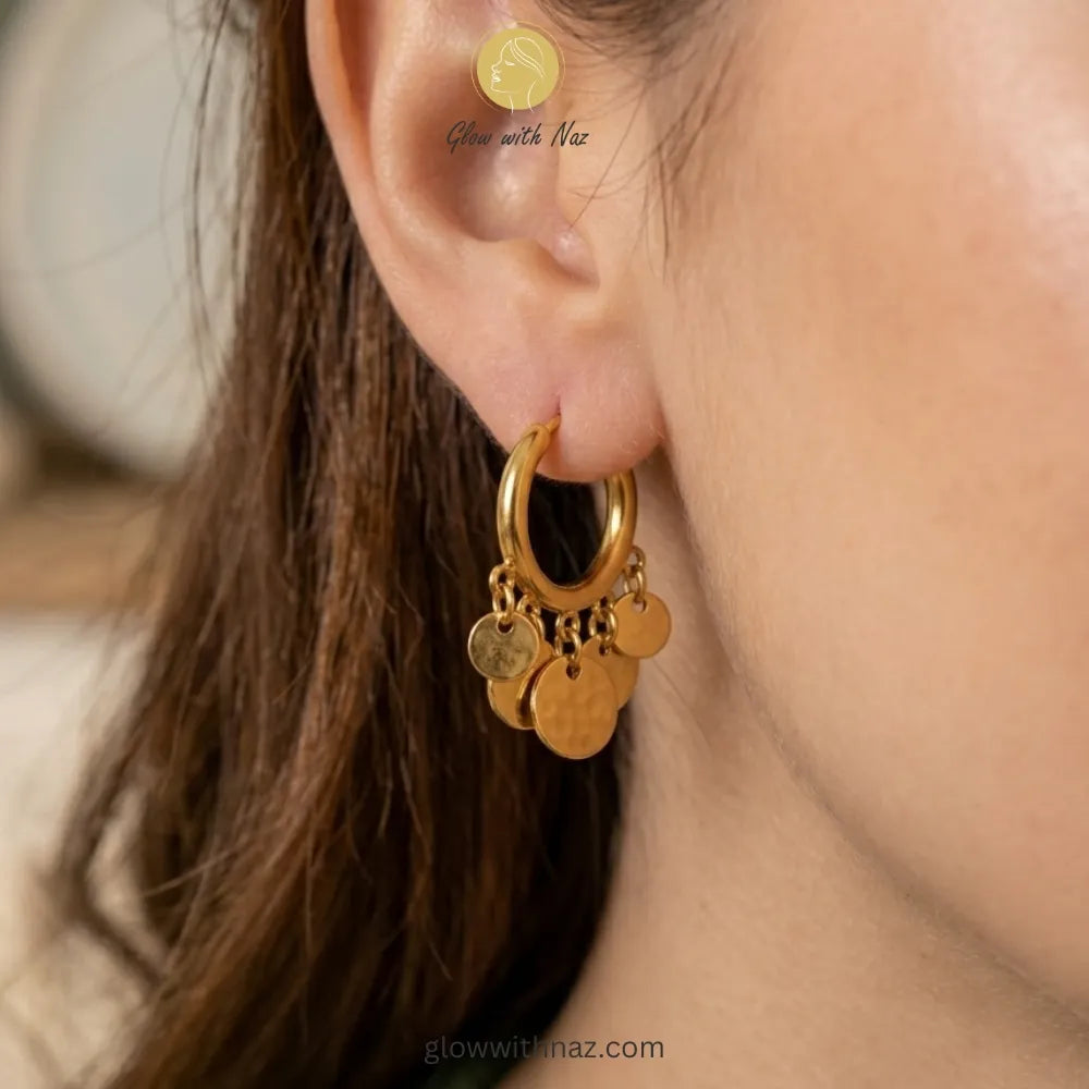 Pair of elegant gold-tone hoop earrings with multiple dangling circular coin charms