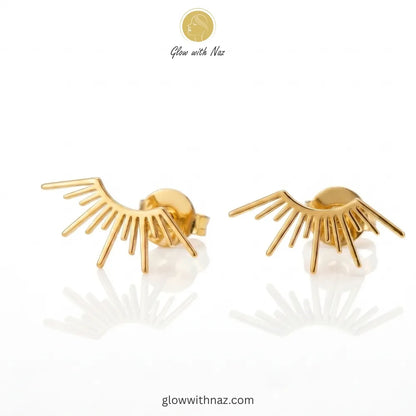 Pair of elegant gold-tone sunburst ray stud earrings on a white background