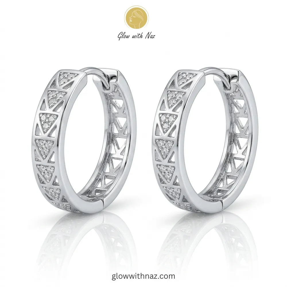 Pair of elegant silver-tone hoop earrings with intricate geometric triangular cut-out patterns