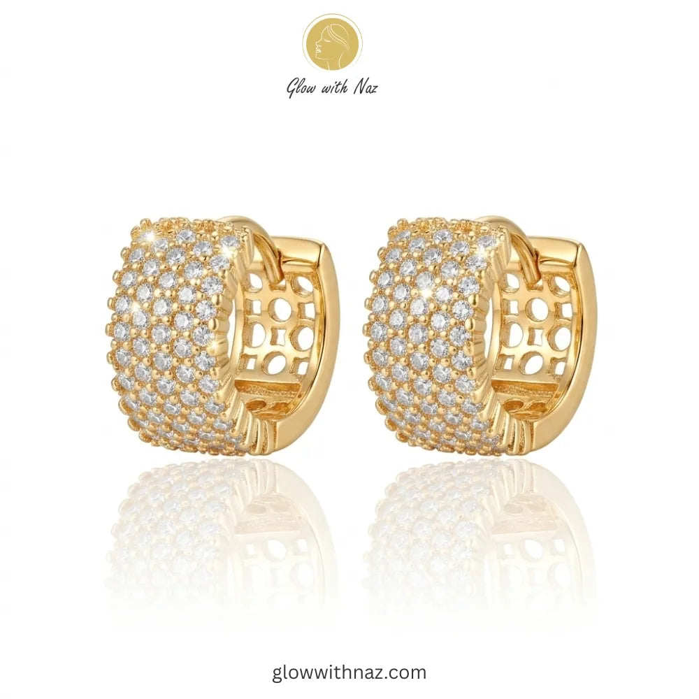 Pair of radiant gold-tone crystal pave hoop earrings featuring intricate side openwork