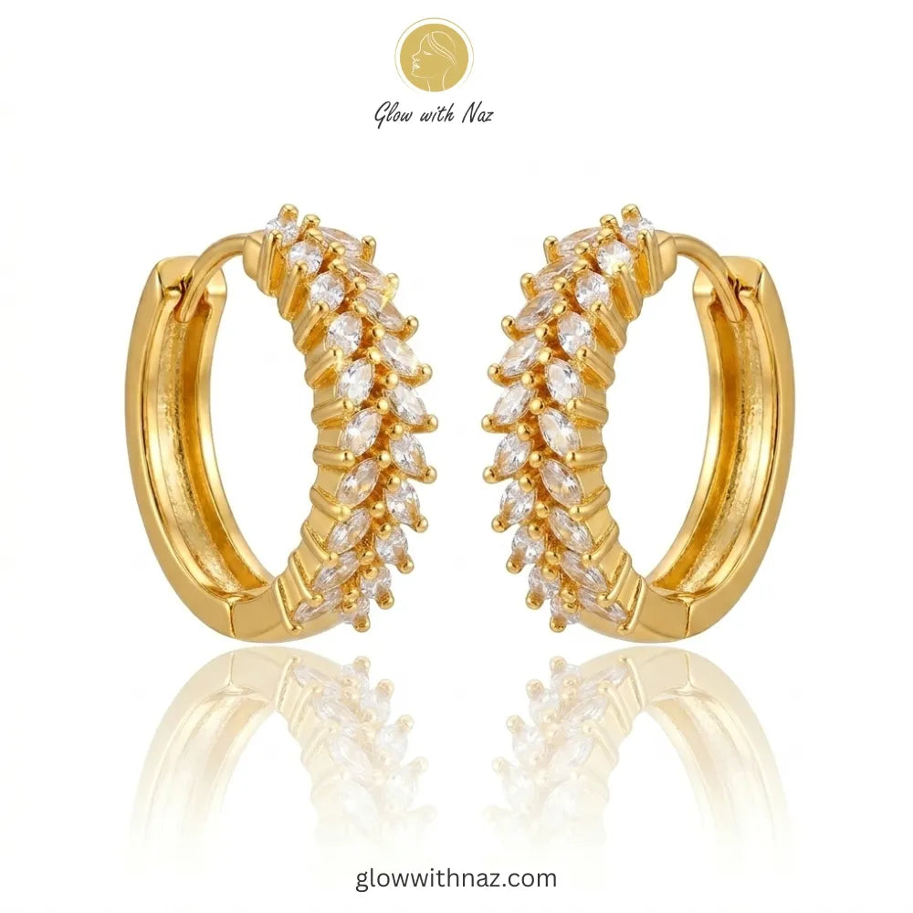 Pair of radiant gold-tone marquise crystal hoop earrings featuring intricate stone settings