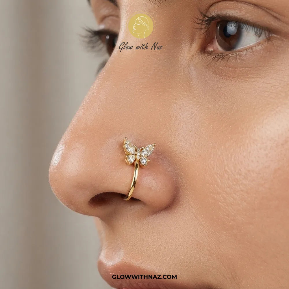 Gold non-pierced chutki butterfly nose pin with clear zircon crystals on white background by Glow With Naz