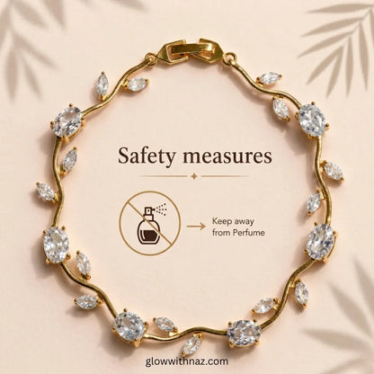Gold wavy bracelet with marquise and oval clear crystals, displayed on a beige background with text reading 'Safety measures' and a perfume prohibition icon. Tulip Rapunzel bracelet, floral tulip bracelet, Rapunzel inspired jewelry, aesthetic tulip bracelet, trendy charm bracelet, stainless steel tulip bracelet, gold plated flower bracelet, delicate floral wrist accessory, cute aesthetic jewelry, viral tulip bracelet, Rapunzel theme accessories, dainty floral bracelet, crystal tulip charm, stacking bracelet