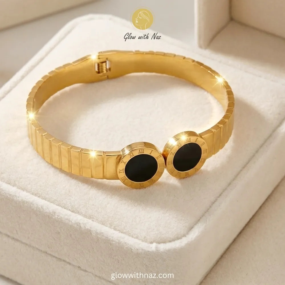Textured gold Roman numeral bangle paired with luxury bracelet stacks
