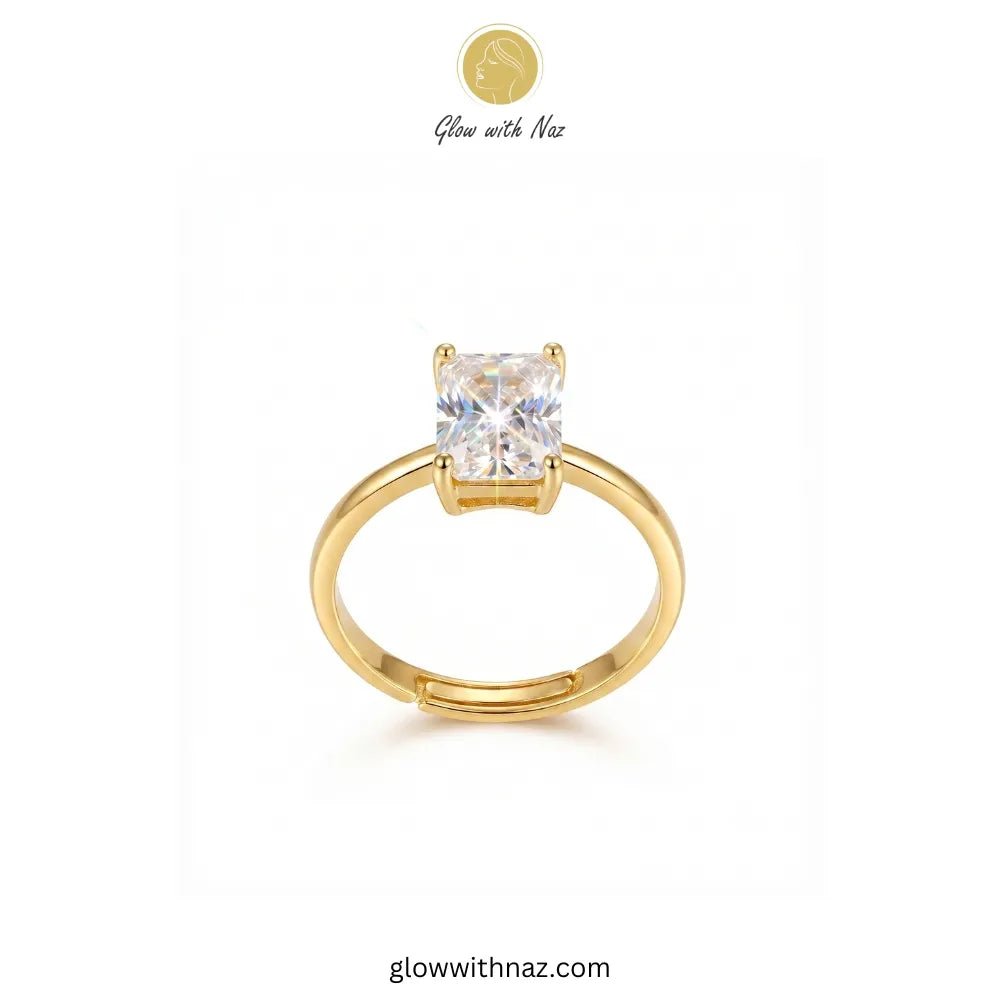 Adjustable Golden Radiant Rectangle Diamond Ring - Adjustable Golden Radiant Rectangle Diamond RingJewelryGlow With NazGlow With NazR021A gold solitaire ring with a square-cut clear gemstone, displayed on a clean white background with a brand logo 'Glow with Naz' at the top. ring, girls rings, rings for girls, rings simple, simple rings, stainless steel jewelry, jewellery set, aesthetic jewelry, simple jewellery, chain, jewelry, artificial jewellery