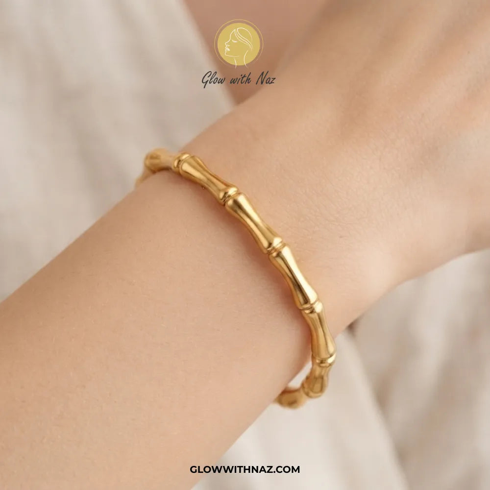 Gold bone segment link cuff bangle worn on model wrist by Glow With Naz