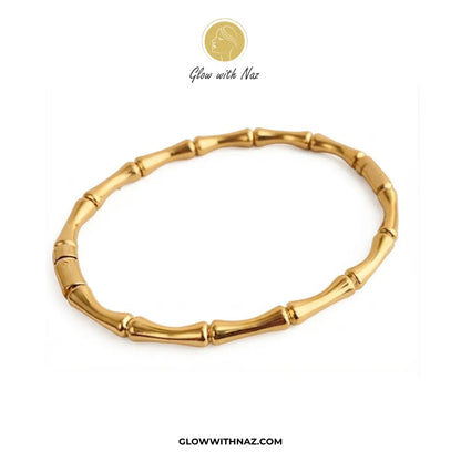 Gold bamboo joint link cuff bangle flat lay view on white background by Glow With Naz