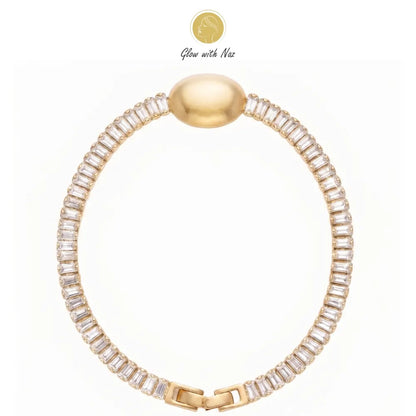 Close-up of a woman's hand wearing the aesthetic crystal oval golden bracelet by Glow With Naz