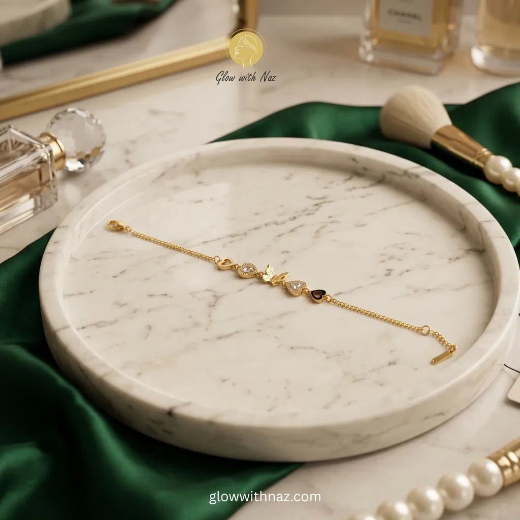 Gold Butterfly & Heart Charm Chain Bracelet - Gold Butterfly & Heart Charm Chain BraceletJewelryGlow With NazGlow With NazN-B028N-B028Gold butterfly and heart charm chain bracelet on marble tray with green satin — anti - tarnish stainless steel dainty bracelet online in Pakistan by Glow with Naz