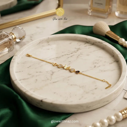 Gold Butterfly & Heart Charm Chain Bracelet - Gold Butterfly & Heart Charm Chain BraceletJewelryGlow With NazGlow With NazN-B028N-B028Gold butterfly and heart charm chain bracelet on marble tray with green satin — anti - tarnish stainless steel dainty bracelet online in Pakistan by Glow with Naz