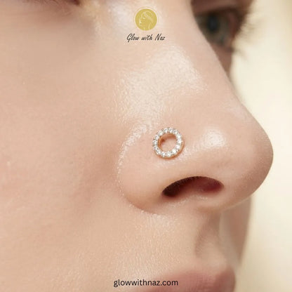 Gold hollow circle CZ stud worn as a nose pin piercing by Glow With Naz
