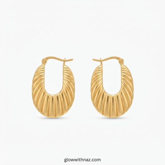 Gold plated stainless steel abstract ribbed oval shell hoop earrings with latch closure by Glow With Naz