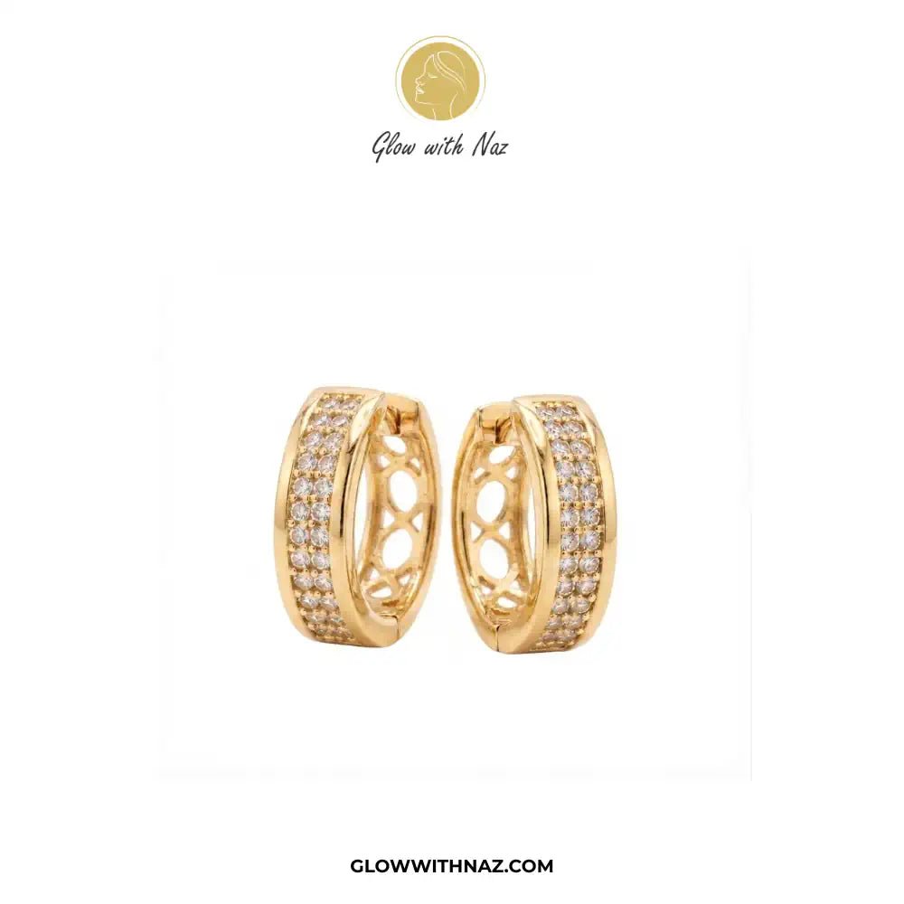 Golden Zircon Mid Size Slide Hoop for Women - Golden Zircon Mid Size Slide Hoop for WomenJewelryGlow With NazGlow With NazE058A pair of gold huggie hoop earrings with pavé-set clear stones and an openwork center design, shown on a white background with the brand logo 'Glow with Naz' at the top and 'GLOWWITHNAZ.COM' at the bottom.