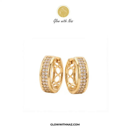 Golden Zircon Mid Size Slide Hoop for Women - Golden Zircon Mid Size Slide Hoop for WomenJewelryGlow With NazGlow With NazE058A pair of gold huggie hoop earrings with pavé-set clear stones and an openwork center design, shown on a white background with the brand logo 'Glow with Naz' at the top and 'GLOWWITHNAZ.COM' at the bottom.