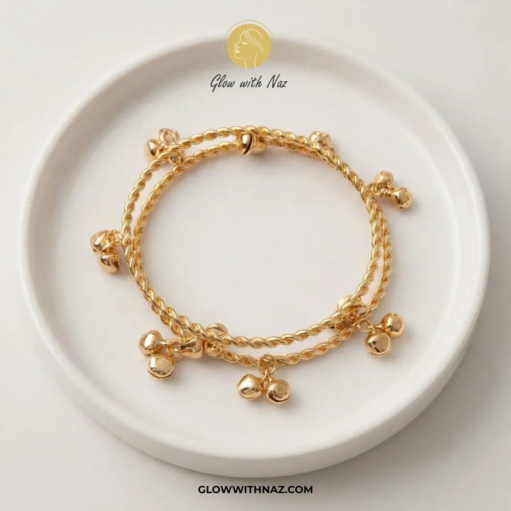 Gold Kashmiri twisted rope ghungroo bangle set of 2 on ceramic dish by Glow With Naz