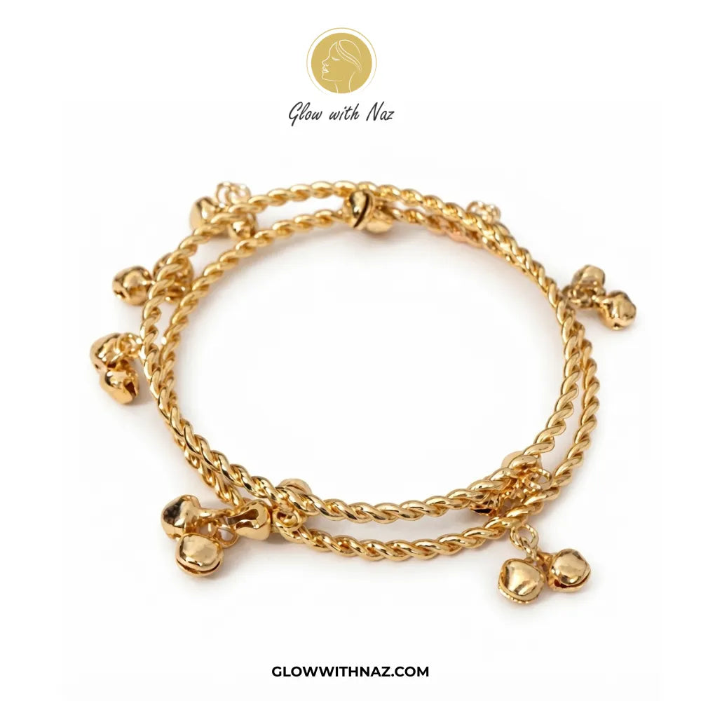 Pair of gold Kashmiri ghungroo twisted bangles flat lay view by Glow With Naz