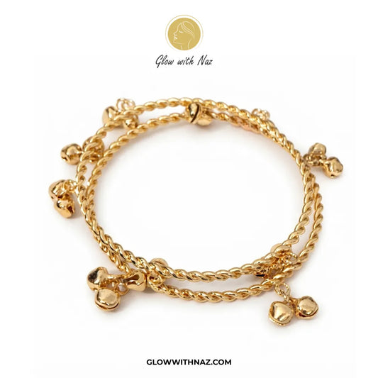 Pair of gold Kashmiri ghungroo twisted bangles flat lay view by Glow With Naz
