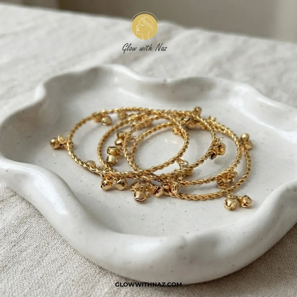 Set of 4 gold Kashmiri ghungroo bangles in decorative ceramic dish by Glow With Naz