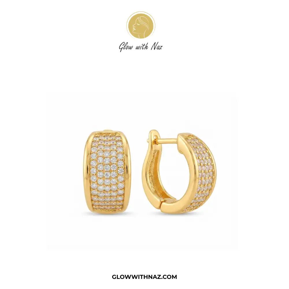 Minimalist Diamond Curvy Hoop Earrings for Girls - Minimalist Diamond Curvy Hoop Earrings for GirlsJewelryGlow With NazGlow With NazE056A pair of gold huggie hoop earrings with pavé-set clear stones, shown on a white background with the brand logo 'Glow with Naz' at the top and 'GLOWWITHNAZ.COM' at the bottom.