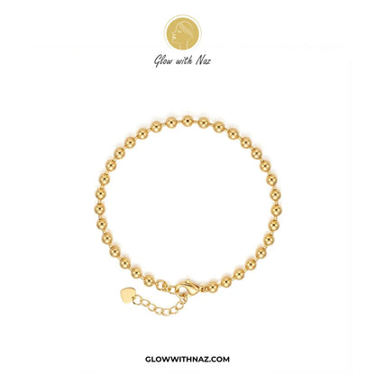 Minimalist gold bead chain bracelet flat lay view on white background by Glow With Naz