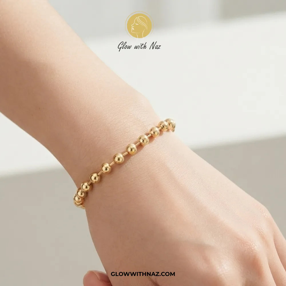 Minimalist gold sphere bead chain bracelet worn on model wrist by Glow With Naz