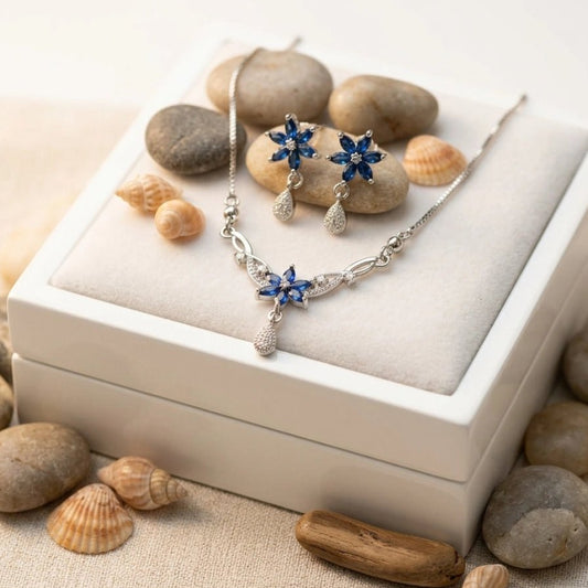 Original Zircon Blue Sapphire Necklace & Earrings Set - Original Zircon Blue Sapphire Necklace & Earrings SetJewelryGlow With NazGlow With NazN-N011N-N011silver floral jewelry set featuring navy blue sapphire - colored petals and sparkling diamond - accented teardrops, including a delicate box chain necklace and matching drop earrings