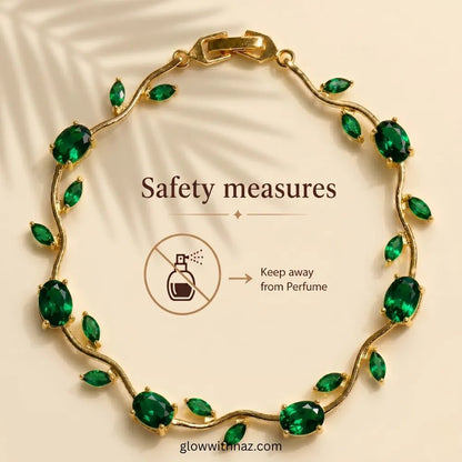 Premium Green Tulip Bracelet | Rapunzel Floral Stainless Steel Bracelet - Premium Green Tulip Bracelet | Rapunzel Floral Stainless Steel BraceletJewelryGlow With NazGlow With NazTB003AGold vine-style bracelet with green marquise and oval stones, shown on a beige background with text reading 'Safety measures' and a perfume icon warning it should be kept away from perfume. Tulip Rapunzel bracelet, floral tulip bracelet, Rapunzel inspired jewelry, aesthetic tulip bracelet, trendy charm bracelet, st
