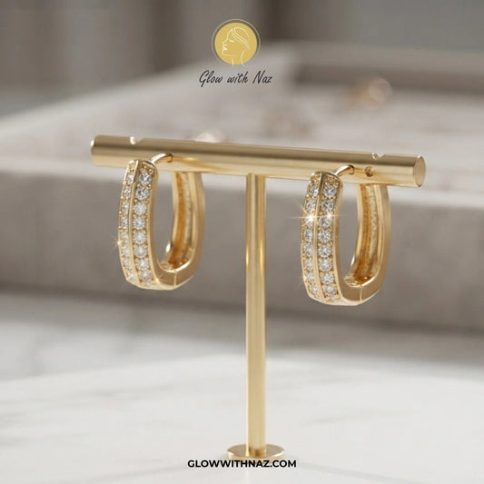 Premium Small Crystal Zircon Square Hoop Earrings - Premium Small Crystal Zircon Square Hoop EarringsJewelryGlow With NazGlow With NazE037A pair of gold hoop earrings with pavé-set clear stones, displayed on a gold T-stand. The brand logo 'Glow with Naz' is visible at the top and 'GLOWWITHNAZ. studs earrings, small earrings, girls earrings, simple earrings, earrings for girls, black earrings, earrings, ear rings, earrings tops, stud earrings, tops earrings, aesthetic earrings, hoop earrings, dro
