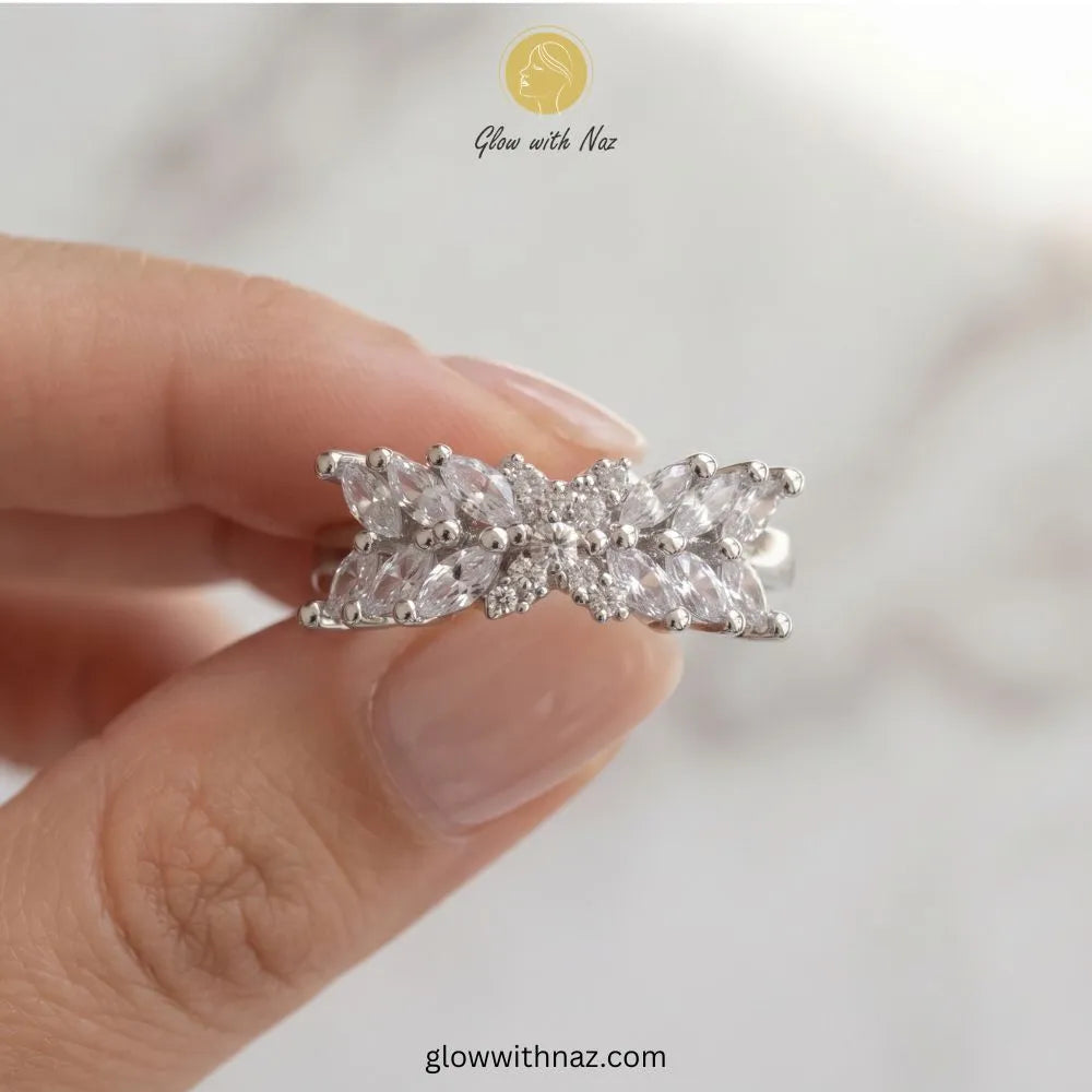 Silver marquise crystal cross ring with clear pave emblem held in hand by Glow With Naz