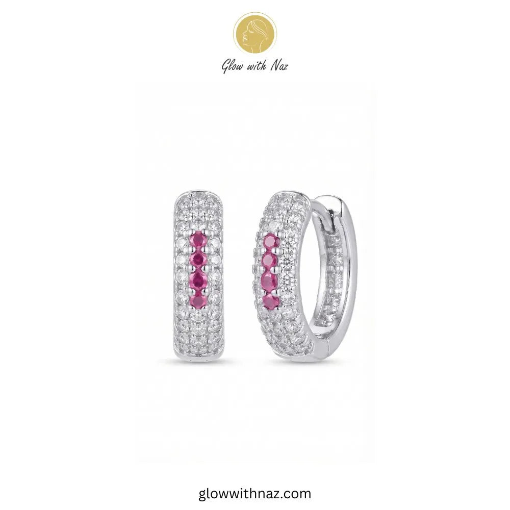Silver multi row pave zircon huggie hoop earrings featuring 4 pink center accent stones by Glow With Naz