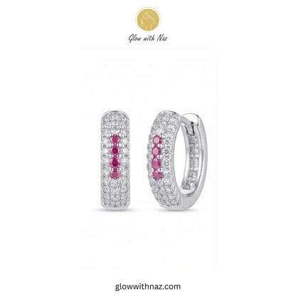 Silver multi row pave zircon huggie hoop earrings featuring 4 pink center accent stones by Glow With Naz