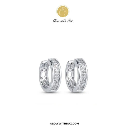 Silver Zircon Mid-Size Slide Hoop Earrings for Women - Silver Zircon Mid-Size Slide Hoop Earrings for WomenJewelryGlow With NazGlow With NazE059A pair of silver huggie hoop earrings adorned with pavé-set clear stones, displayed on a clean white background with the brand logo 'Glow with Naz' at the top and 'GLOWWITHNAZ.COM' at the bottom.