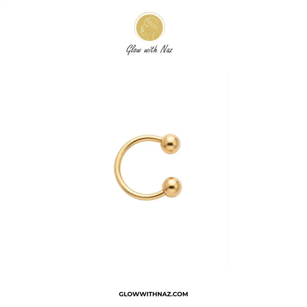 Stainless Steel Horseshoe 8.5 mm C Nose Ring & Helix Ear Piercing Jewelry - Stainless Steel Horseshoe 8.5 mm C Nose Ring & Helix Ear Piercing JewelryJewelryGlow With NazGlow With NazNR004A gold-colored curved barbell piercing stud with two ball end caps, shown on a plain white background with the brand logo 'Glow with Naz' at the top and the website 'GLOWWITHNAZ.COM' at the bottom. nose ring, helix piercing jewelry, cartilage earring, horseshoe piercing, septum ring, stainless steel jewelry, bod