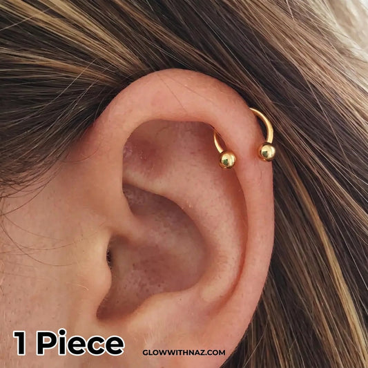 Stainless Steel Horseshoe 8.5 mm C Nose Ring & Helix Ear Piercing Jewelry - Stainless Steel Horseshoe 8.5 mm C Nose Ring & Helix Ear Piercing JewelryJewelryGlow With NazGlow With NazNR004A close-up of a person's ear featuring a small gold hoop piercing on the upper helix, with strands of brown hair visible around it. nose ring, helix piercing jewelry, cartilage earring, horseshoe piercing, septum ring, stainless steel jewelry, body jewelry, hypoallergenic nose ring, gold nose ring, helix hoop, t
