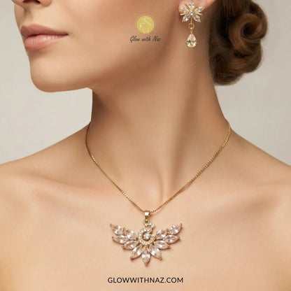 Tarnish-Free Trending Peacock Earring & Pendant Set - #Tarnish-Free Trending Peacock Earring & Pendant SetJewelryGlow With NazGlow With NazN0069A close-up of a woman wearing a gold necklace with a winged pendant and matching drop earrings. The jewelry features clear rhinestones and is branded with 'Glow with Naz' and 'GLOWWITHNAZ.#