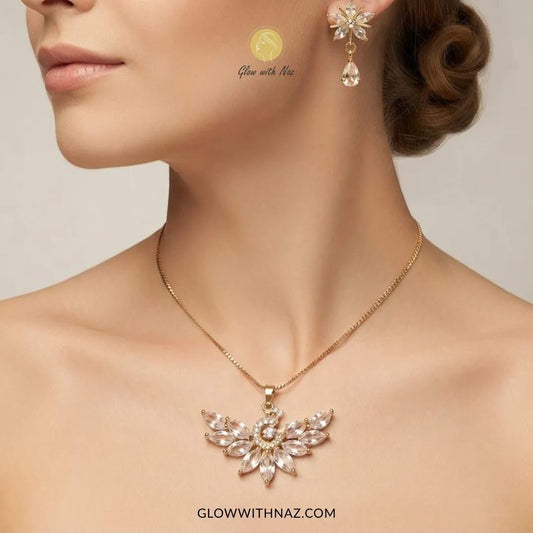 Tarnish-Free Trending Peacock Earring & Pendant Set - #Tarnish-Free Trending Peacock Earring & Pendant SetJewelryGlow With NazGlow With NazN0069A close-up of a woman wearing a gold necklace with a winged pendant and matching drop earrings. The jewelry features clear rhinestones and is branded with 'Glow with Naz' and 'GLOWWITHNAZ.#