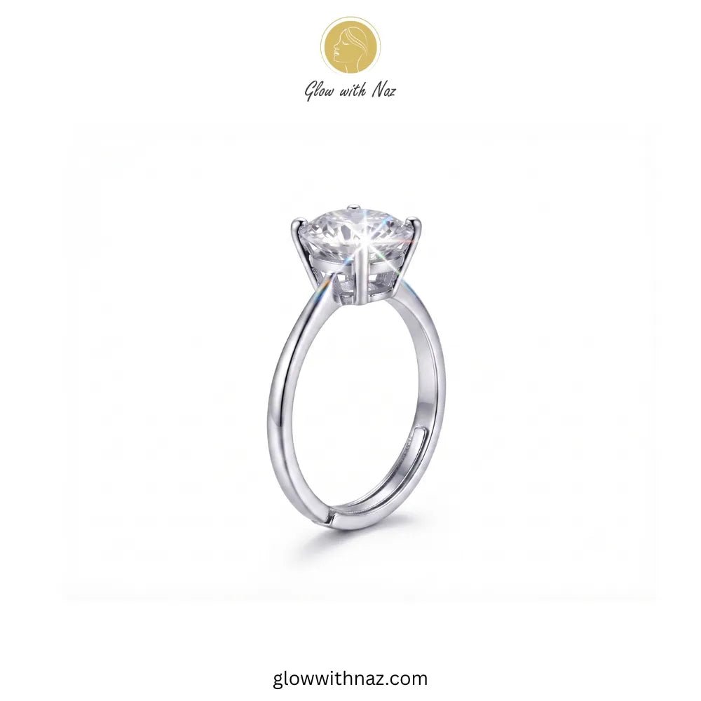 The Signature Adjustable Big Round Silver Diamond Ring - The Signature Adjustable Big Round Silver Diamond RingJewelryGlow With NazGlow With NazR025A silver solitaire engagement ring with a round brilliant-cut diamond center stone, shown on a plain white background with the brand logo 'Glow with Naz' at the top. ring, girls rings, rings for girls, rings simple, simple rings, stainless steel jewelry, jewellery set, aesthetic jewelry, simple jewellery, chain, jewelry, artificial jewellery