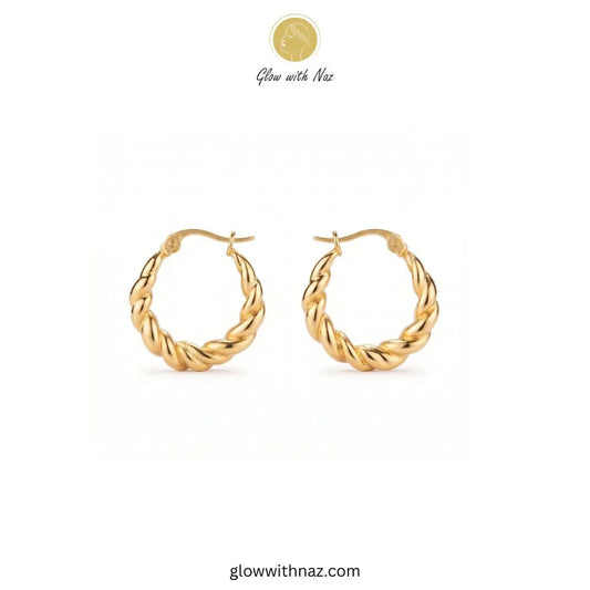 Gold thick twisted baali stainless steel hoop earrings worn on ear model by Glow With Naz