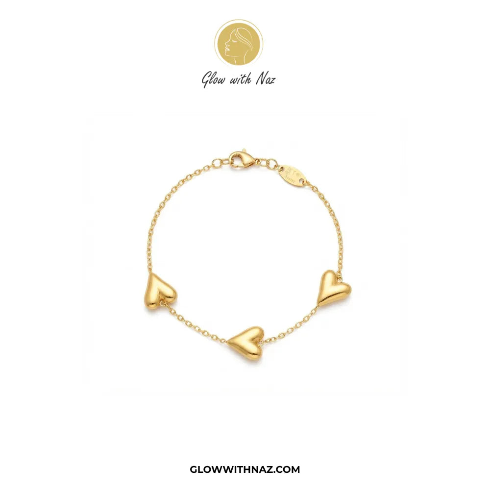 Gold chain bracelet with three 3D balloon hearts flat lay view by Glow With Naz