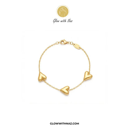 Gold chain bracelet with three 3D balloon hearts flat lay view by Glow With Naz