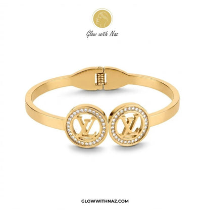 Twin LV Medallion Crystal Handcuff Bangle in Gold - #Twin LV Medallion Crystal Handcuff Bangle in GoldJewelryGlow With NazGlow With NazB0065Gold dual monogram crystal halo handcuff bangle front view by Glow With Naz#