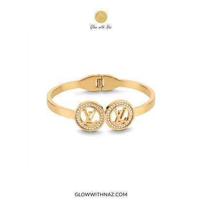 Twin LV Medallion Crystal Handcuff Bangle in Gold - #Twin LV Medallion Crystal Handcuff Bangle in GoldJewelryGlow With NazGlow With NazB0065Gold twin LV medallion crystal handcuff bangle flat lay view by Glow With Naz#