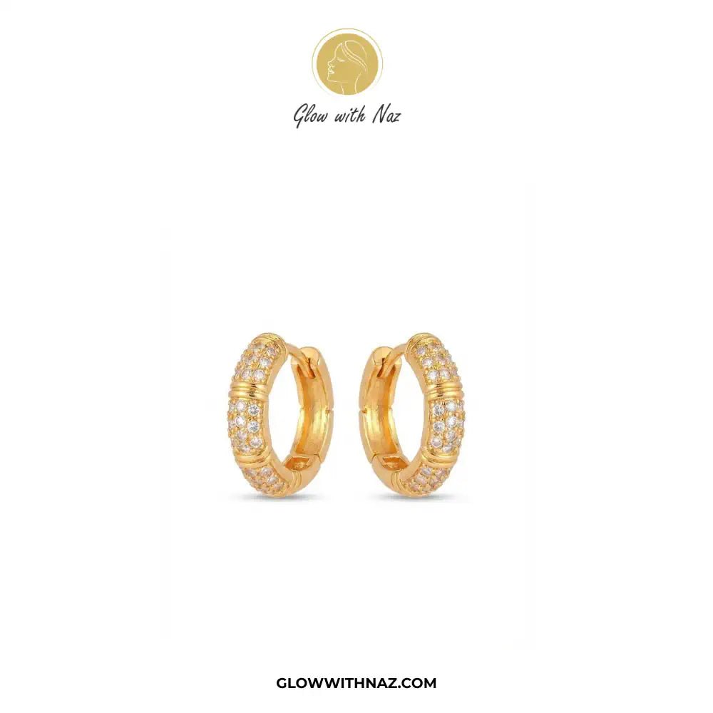 Zircon 3 Bar Mini Hoops Earrings - #Zircon 3 Bar Mini Hoops EarringsJewelryGlow With NazGlow With NazE057A pair of gold huggie hoop earrings with pavé-set clear stones, displayed on a clean white background with the brand logo 'Glow with Naz' at the top and the website 'GLOWWITHNAZ.COM' at the bottom.#